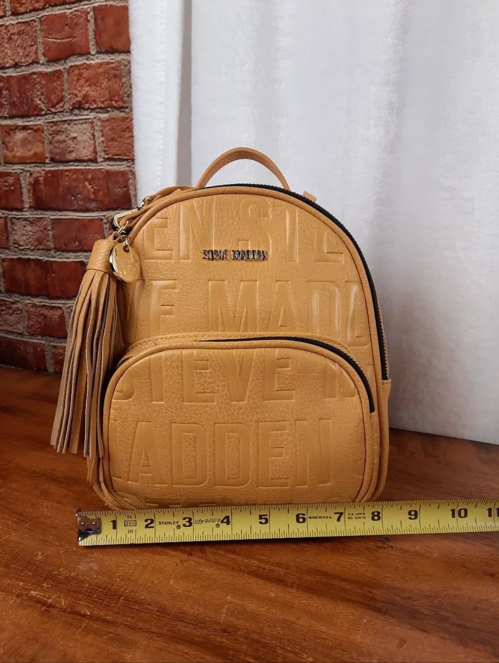 Steve Madden Mustard Mini Tassel Backpack